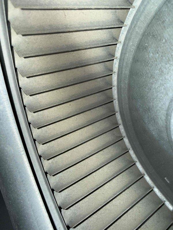 Completed MVP cooling maintenance visit on residential HVAC system. Performed comprehensive inspection of air handler assembly, documenting blower wheel condition with visible dust and debris accumulation on squirrel cage fan fins and surrounding components. Measured and recorded electrical readings using calibrated digital multimeter, confirming system amperage draw of 66.0 amps during operation to verify proper motor performance and identify any potential electrical concerns.