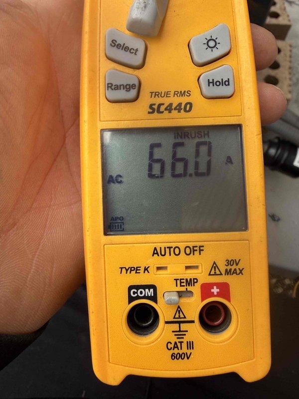 Completed MVP cooling maintenance visit on residential HVAC system. Performed comprehensive inspection of air handler assembly, documenting blower wheel condition with visible dust and debris accumulation on squirrel cage fan fins and surrounding components. Measured and recorded electrical readings using calibrated digital multimeter, confirming system amperage draw of 66.0 amps during operation to verify proper motor performance and identify any potential electrical concerns.