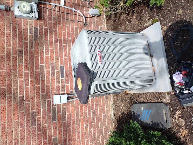 Completed MVP recurring cooling maintenance visit on outdoor air conditioning condenser unit. Performed comprehensive system inspection including examination of exterior cabinet condition, electrical connections at control board, and overall unit operation. Documented equipment condition with photographic records showing condenser placement, top grille assembly, and internal control board wiring configuration. All components inspected and system verified operational per maintenance protocol.