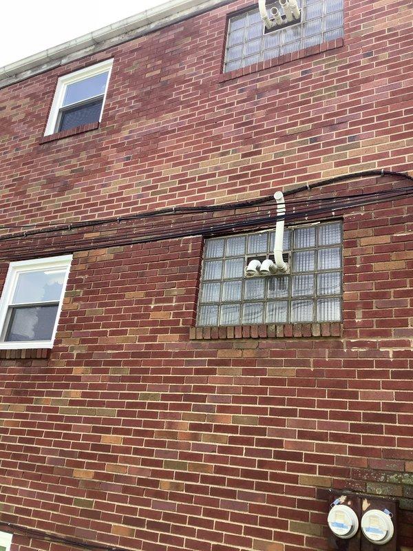 Conducted comprehensive electrical assessment of 6-unit apartment building to provide estimate for complete service upgrade. Evaluated existing service entrance, determined requirements for new drop band installation from street to main service entrance point, and assessed current meter socket configuration for replacement with new individual metering for each unit. Inspected aging electrical panels throughout building, noting deteriorated equipment with significant rust and wear requiring full replacement with new main panels for all six units and new sub-panels as needed. Examined existing conduit routing and wiring infrastructure in common areas, including detailed inspection of laundry room electrical systems to verify code compliance and safety conditions. Documented all findings with photographs of exterior service entrance area showing current meter locations and interior utility spaces displaying existing panel conditions and wiring configurations to support comprehensive proje