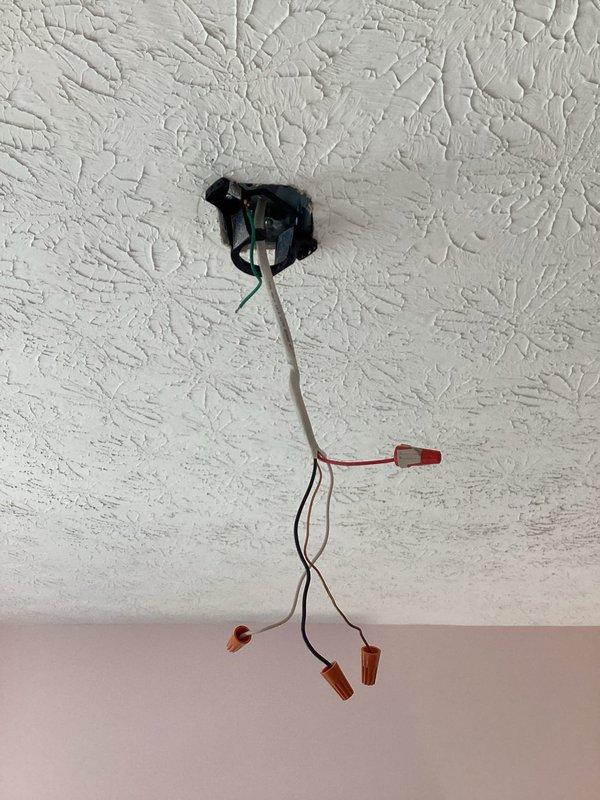 Responded to circuit breaker tripping issue after ceiling fan removal. Inspected electrical junction box and wiring connections in ceiling fixture location. Found exposed wiring with multiple wire nut connections requiring evaluation. Documented existing electrical configuration and exterior service equipment for troubleshooting purposes.