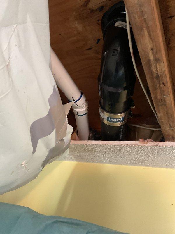 Replaced corroded toilet closet flange that was causing moisture issues on the bathroom floor. Accessed the 3-inch drain pipe through the kitchen ceiling, cut out the deteriorated section, and rebuilt the drain assembly with new closet flange and proper mounting hardware. Installed protective plastic sheeting below the work area to prevent debris from damaging kitchen cabinetry during the repair process.