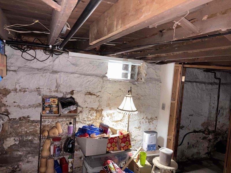 Conducted comprehensive electrical estimate for standby generator installation at residential property. Assessed existing basement electrical infrastructure, including exposed wiring runs along ceiling joists and current panel capacity. Documented site conditions through photographic survey of proposed installation area in unfinished basement space with stone/concrete block walls and exposed structural elements. Evaluated access pathways for equipment placement, fuel line routing options, and transfer switch location. Identified necessary electrical upgrades to accommodate generator system integration with existing service. Provided detailed scope of work and material requirements for automatic transfer switch installation and generator connection to main electrical panel.