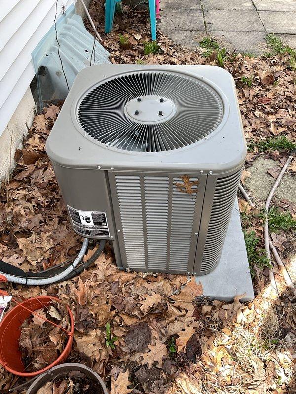 Completed routine AC tune-up on residential outdoor condenser unit. Inspected electrical connections, contactor, and wiring within compartment; verified proper grounding and terminal tightness. Cleared debris and leaves from around unit and concrete pad to ensure adequate airflow and proper operation.