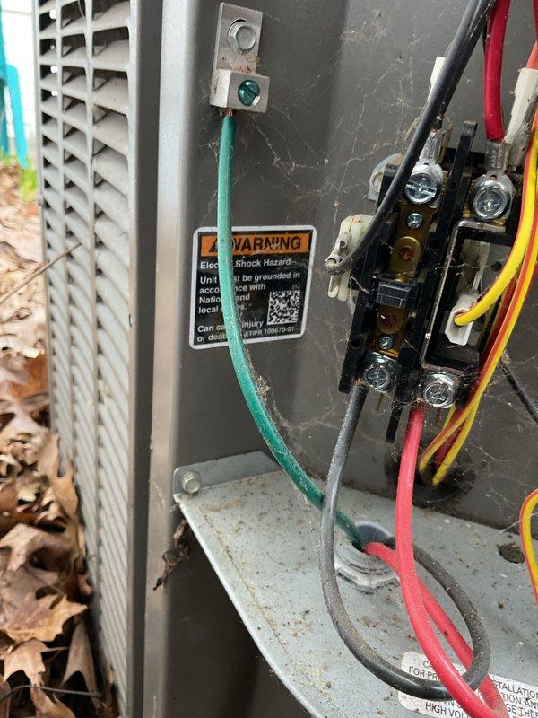 Completed routine AC tune-up on residential outdoor condenser unit. Inspected electrical connections, contactor, and wiring within compartment; verified proper grounding and terminal tightness. Cleared debris and leaves from around unit and concrete pad to ensure adequate airflow and proper operation.