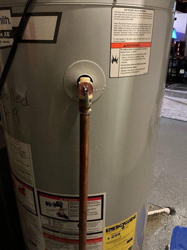 Responded to report of leaking pressure relief valve on tanked water heater. Upon arrival, confirmed active leak from T&P relief valve assembly mounted on side of unit. Replaced defective pressure relief valve with new component from truck stock, tested operation to ensure proper function and verified no additional leaks present at connection points.
