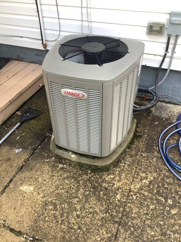 Completed preventive maintenance visit on residential Lennox air conditioning system. Performed standard cooling season inspection of outdoor condenser unit, including visual assessment of cabinet condition, electrical connections, and refrigerant lines. Unit found to be operational with no immediate service needs identified. Noted moderate weathering and biological growth on concrete pad surrounding equipment, though this does not affect system performance. All electrical components including disconnect box and conduit connections inspected and found secure.