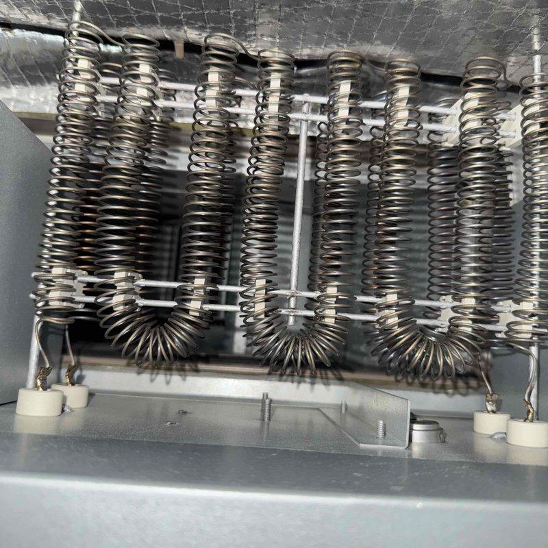 Performed comprehensive tune-up on combined heating and cooling system in residential condo unit. Conducted full system inspection including electrical measurements using digital multimeter, recording 692-volt reading on heating elements. Inspected electric heating coil assembly, verified all coil springs intact and properly mounted on frame with ceramic insulators in good condition and electrical connections secure. Cleaned and tested all components, confirmed system operational and ready for continued service.