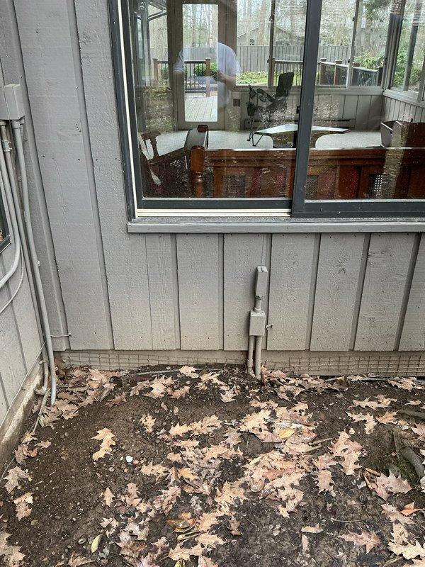 Conducted on-site evaluation for mini split installation at residential property. Assessed exterior wall locations and existing electrical infrastructure, including junction box and conduit placement on beige vinyl siding near sliding glass door. Documented installation pathway requirements and photographed proposed equipment placement areas on enclosed porch and deck spaces to determine optimal indoor and outdoor unit positioning for system efficiency.