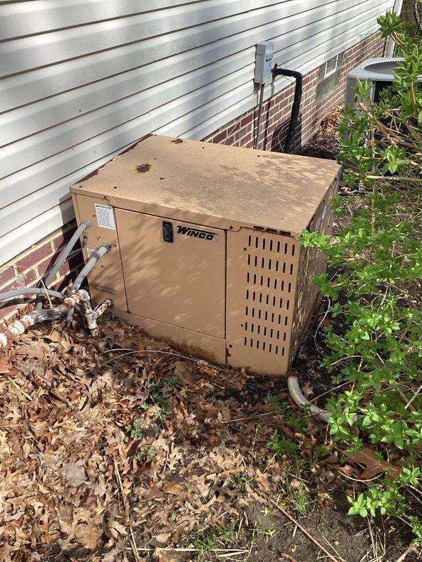 Responded to service call for non-operational Winco generator at residential property. Upon arrival, inspected 22-year-old generator unit located on exterior of building. Found failed battery preventing generator from starting. Removed deteriorated battery dated 6-23 from unit. Replaced with new battery, restored generator to proper working condition, and verified successful operation through startup test.