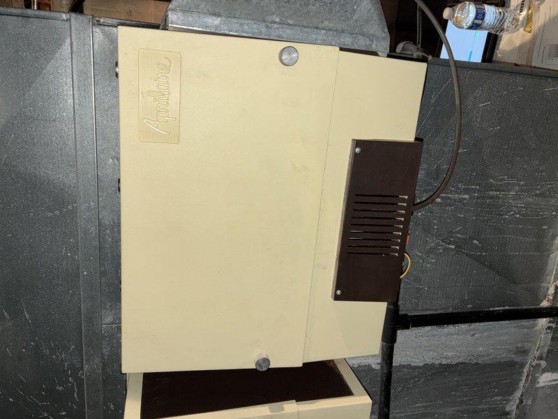 Completed MVP recurring cooling maintenance visit on rooftop HVAC system. Inspected Aprilaire air handler unit, examined evaporator coil with diamond-pattern mesh filter media, and verified proper electrical connections and wire routing. All components found in satisfactory operating condition with no immediate service needs identified.