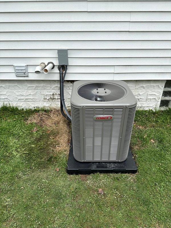 # HVAC Install - Complete System

Completed installation of a 90% efficiency furnace and air conditioning system at residential property. Installed new Lennox ML13KC1-024-230A01 outdoor condensing unit with R-454B refrigerant, rated at 208/230V, single phase, 60Hz. Unit was properly positioned on black composite pad with adequate clearance from structure. Established all required electrical connections via weatherproof conduit and junction box mounted to exterior wall. Installed PVC condensate drainage lines with proper pitch and termination points. Verified all manufacturer specifications for electrical ratings, including compressor RLA/LRA values and fan motor requirements. System tested and confirmed operational, with all safety labels and certifications visible and intact. Installation meets current code requirements for outdoor HVAC equipment placement and clearances.