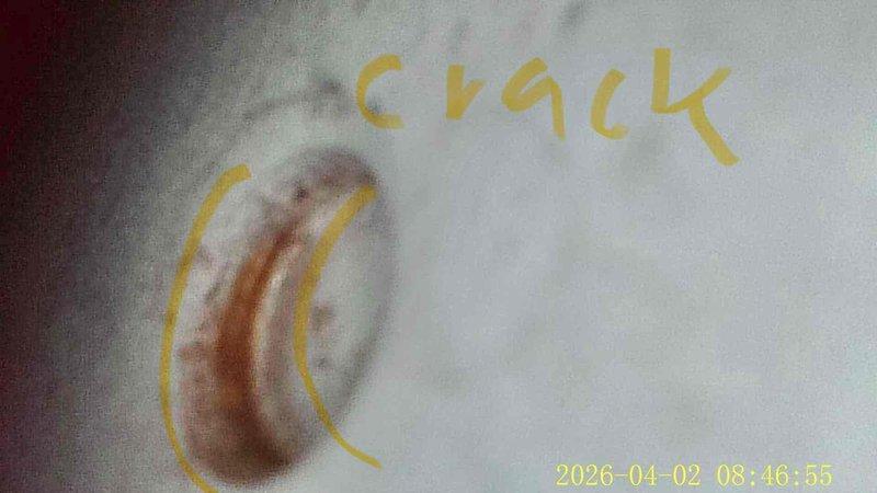 Responded to follow-up service call regarding unplugged opening in furnace piping left from previous heating maintenance visit. Located and inspected the open hole in pipe, documented crack and damage visible in the interior surface of the cylindrical duct with photographic evidence. Successfully sealed and plugged the opening to restore system integrity and prevent air infiltration that could compromise heating efficiency.