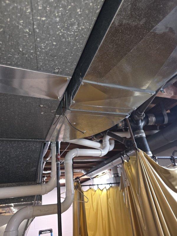 Responded to callback regarding temperature inconsistencies following recent furnace installation. Customer reported thermostat set at 71 degrees but bedrooms and bathroom reaching 81 degrees overnight when doors were closed. Performed system inspection and diagnostics of newly installed furnace unit, ductwork distribution, and airflow balance. Documented equipment installation and mechanical room configuration with photos showing furnace, air handler, PVC venting, refrigerant lines, and ductwork routing through basement mechanical space.