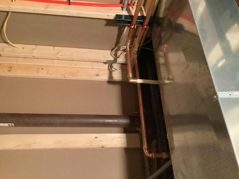 Replaced existing 40-gallon electric tank water heater with Navien NPE 240A2 tankless unit to address insufficient hot water capacity. Installed new electrical outlet to supply power to the unit. Configured venting system with exhaust and fresh air intake routed through left side of structure. Cut and installed MegaPress tee connection into existing 1-inch gas supply line for fuel source. Adapted existing CPVC water supply connections to interface with new tankless system using appropriate transition fittings. All copper piping, gas connections, and water lines installed per manufacturer specifications and local code requirements. Unit tested and operational upon completion.