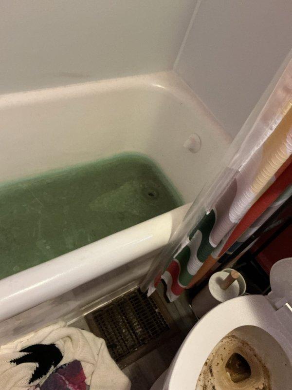 Responded to service call for multiple clogged drains affecting both bathtubs and toilet. Upon arrival, found standing water with significant discoloration in bathtub, indicating severe drainage blockage in the main line. Assessed plumbing system and provided detailed quote for drain clearing services to address the backup affecting multiple fixtures throughout the bathroom.