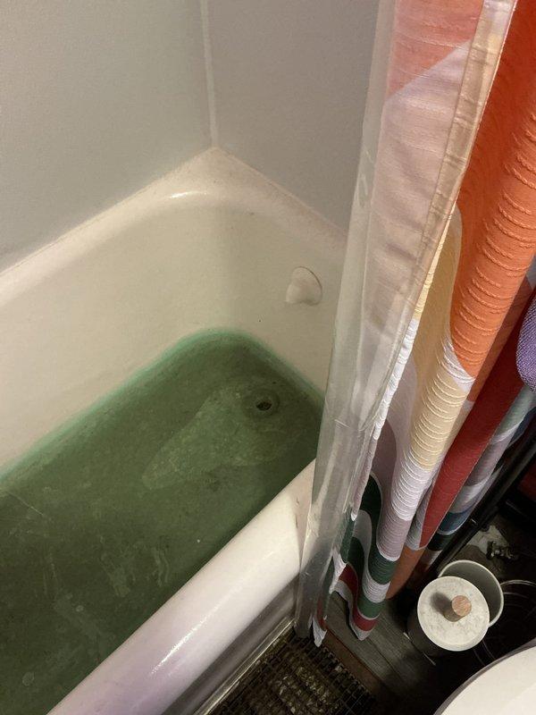 Responded to service call for multiple clogged drains affecting both bathtubs and toilet. Upon arrival, found standing water with significant discoloration in bathtub, indicating severe drainage blockage in the main line. Assessed plumbing system and provided detailed quote for drain clearing services to address the backup affecting multiple fixtures throughout the bathroom.