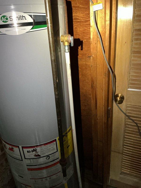Performed comprehensive inspection of 5-year-old A.O. Smith natural gas water heater following basement flooding incident. Evaluated unit for water damage, checked all connections, valves, and safety components for proper operation and structural integrity. Documented current condition of water heater, plumbing connections, venting system, and seismic strapping; confirmed unit operational with no immediate repairs required at time of inspection.