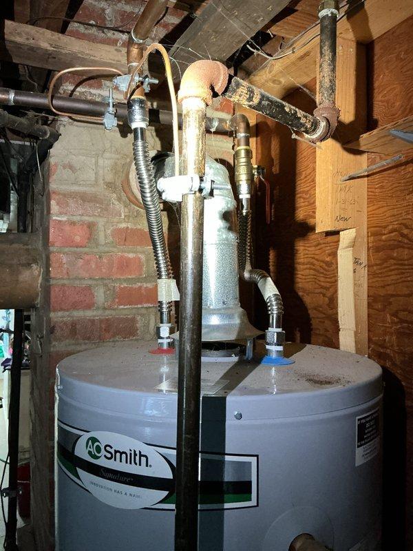 Performed comprehensive inspection of 5-year-old A.O. Smith natural gas water heater following basement flooding incident. Evaluated unit for water damage, checked all connections, valves, and safety components for proper operation and structural integrity. Documented current condition of water heater, plumbing connections, venting system, and seismic strapping; confirmed unit operational with no immediate repairs required at time of inspection.