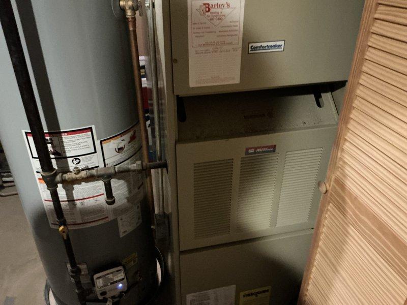 Conducted on-site assessment for furnace replacement due to no heat condition. Evaluated existing Comfortmaker HVAC system and water heater installation in residential utility closet, documented equipment specifications and configuration, photographed current setup including copper piping connections and brass fittings, and prepared comprehensive replacement estimate for new heating system.