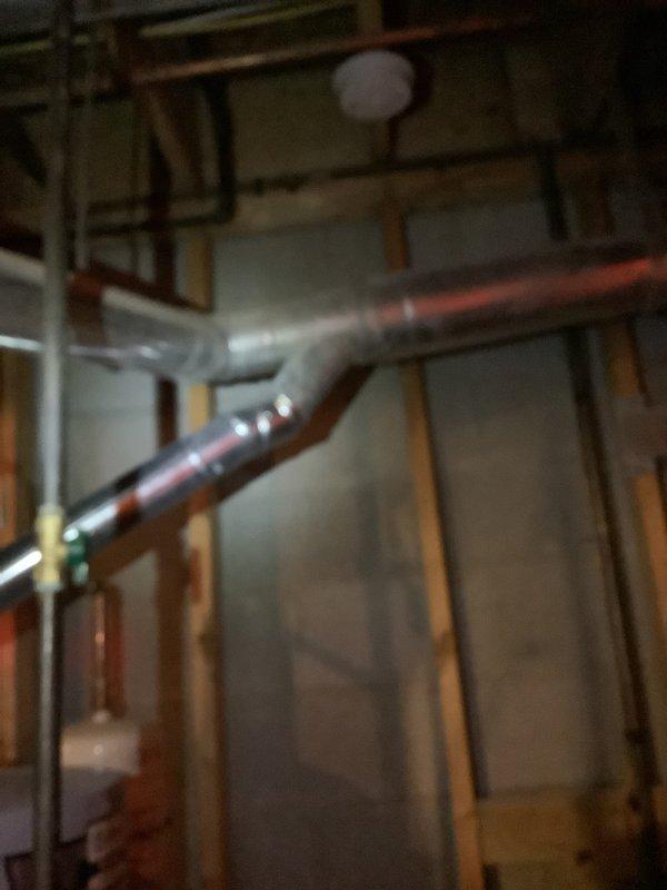 Conducted on-site assessment for complete HVAC system replacement including air conditioning unit and furnace in residential property. Evaluated existing infrastructure in unfinished basement area, documenting current ductwork configuration, exposed piping systems, and available installation space among floor joists and wall framing. Photographed mechanical room layout and utility connections to prepare comprehensive equipment replacement estimate for buy-one-get-one promotion qualifying system upgrade.