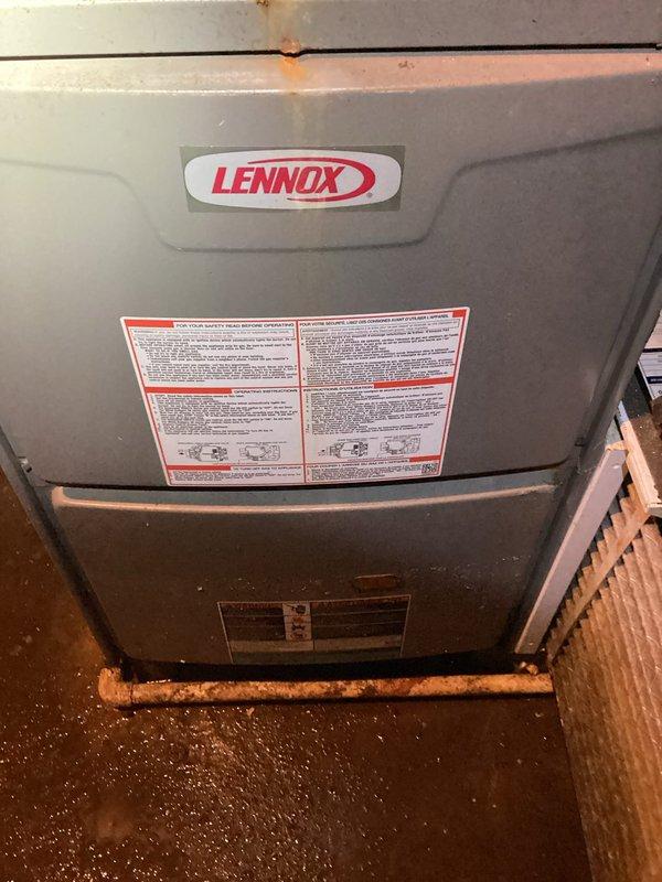 Responded to no-heat call on Lennox furnace in flooded basement. Upon arrival, found standing water throughout utility area due to recent flooding, which had compromised the air filter and affected system operation. Inspected furnace and surrounding components, noting water damage to basement space and corroded copper piping. Replaced water-damaged air filter with new unit. Verified furnace restored to proper operation and heating capability. Documented flood conditions and equipment status with photos for customer records.