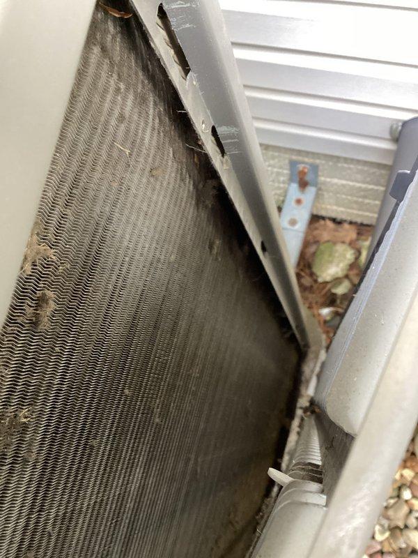 # HVAC Maintenance - Cooling

Completed recurring MVP cooling maintenance visit on outdoor condensing unit. Upon arrival, performed comprehensive inspection of condenser coil which revealed significant accumulation of dirt, dust, and debris throughout the fin structure, along with algae and moss growth on lower frame components from prolonged moisture exposure. Thoroughly cleaned condenser coil fins to remove environmental contaminants and restore proper airflow and heat transfer efficiency. Inspected electrical components and wiring for proper operation and secure connections. Unit returned to optimal operating condition with improved airflow through coil assembly.