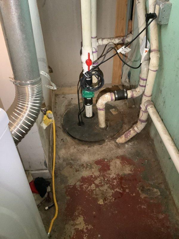 Replaced failed grinder pump unit in basement sump basin. Removed existing pump assembly, installed new grinder pump with proper discharge piping connections, secured check valve with hose clamps, and tested system operation. Verified electrical connections and confirmed proper pump function with no leaks detected.