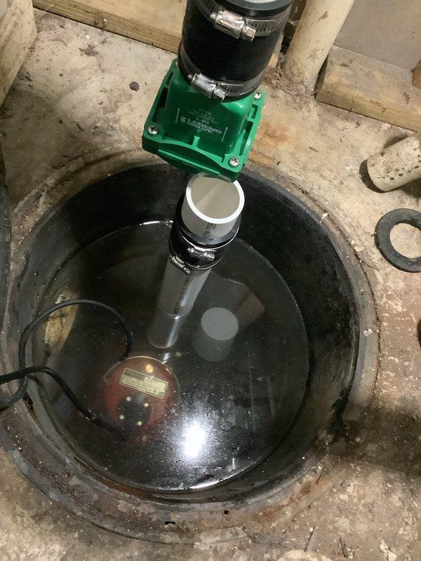 Replaced failed grinder pump unit in basement sump basin. Removed existing pump assembly, installed new grinder pump with proper discharge piping connections, secured check valve with hose clamps, and tested system operation. Verified electrical connections and confirmed proper pump function with no leaks detected.