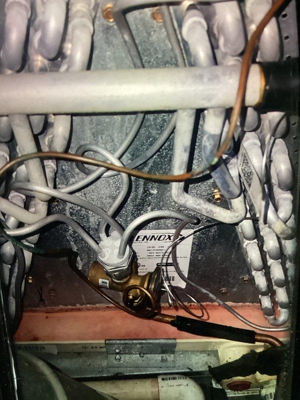 Completed scheduled heating maintenance visit for MVP program customer. Upon inspection, discovered significant frost and ice accumulation on evaporator coil and refrigerant suction lines in Lennox HVAC unit, indicating potential airflow restriction or refrigerant system issue. Documented equipment condition with photos showing extensive frost buildup on copper lines and coil assembly for further diagnostic evaluation and repair recommendations.