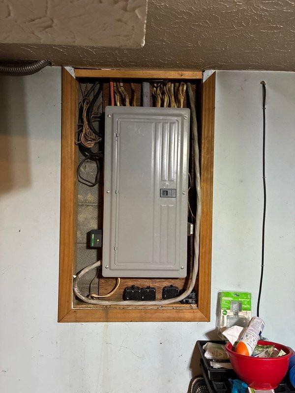 Installed a 50-amp generator inlet to the right of exterior water spigot to accommodate a 13,000 peak watt/10,000 running watt generator. Cut and installed an 8x8 access panel above the inlet location to facilitate wire routing to the main electrical panel. Ran 6-3 Romex from the inlet to the panel, relocated the furnace breaker to accommodate the new generator breaker, replaced the furnace breaker with properly sized unit, and installed a new surge protector in the panel.