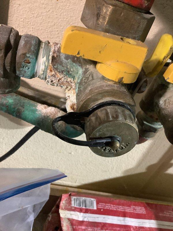 Performed routine flush and maintenance service on gas-fired tankless water heater unit. Removed front access panel to expose internal components, heat exchanger, and control systems. Isolated water supply using existing shut-off valves on inlet and outlet lines, then connected flushing equipment to service ports. Circulated descaling solution through heat exchanger to remove mineral deposits and scale buildup. Inspected gas supply line connections, yellow-handled shut-off valves, and flexible gas line for proper operation and potential leaks. Examined corroded brass fittings and shut-off valves showing significant oxidation, mineral deposits, and green patina buildup, indicating age-related deterioration and moisture exposure. Checked PEX water supply lines, exhaust venting system with PVC piping, burner assembly, copper tubing connections, and electrical wiring harnesses for proper condition. Verified control board operation and all internal components functioning correctly. Flushed 