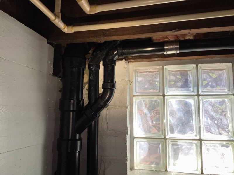 Replaced damaged ABS drainage piping in basement, including cutting and removing 3" pipe on first floor at cabinet location and 6" above the 4" upsize transition point in basement. Cut and replaced 1 1/2" kitchen drain line. Installed new ABS piping to repair cracked fitting and removed temporary tape from 45-degree elbow in basement. System was pressure tested upon completion to verify all leaks were eliminated and drainage system restored to proper function.