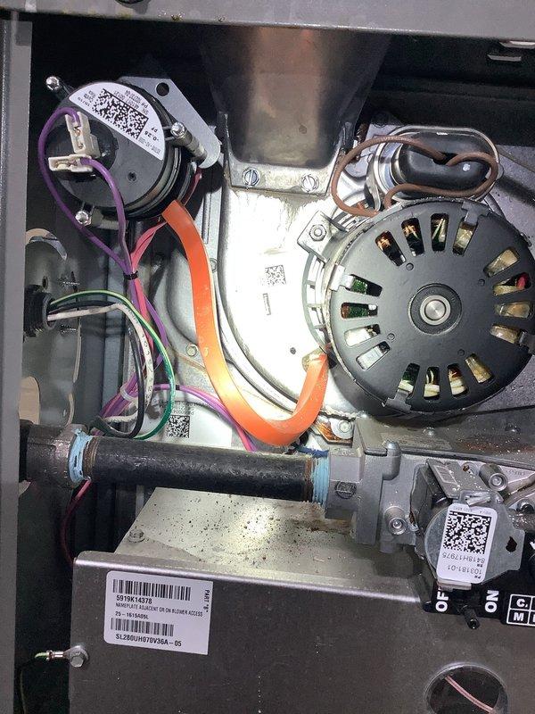 Responded to no heat call on six-year-old Lennox furnace that was not turning on. Upon inspection, accessed blower compartment and identified pressure switch with connected sensing tubes and wiring. Verified electrical connections, inspected blower motor assembly, and checked condensate drainage system. Documented system components including ductwork, PVC venting, and control wiring for service records.