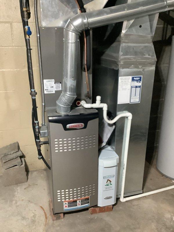 Responded to no heat call on six-year-old Lennox furnace that was not turning on. Upon inspection, accessed blower compartment and identified pressure switch with connected sensing tubes and wiring. Verified electrical connections, inspected blower motor assembly, and checked condensate drainage system. Documented system components including ductwork, PVC venting, and control wiring for service records.