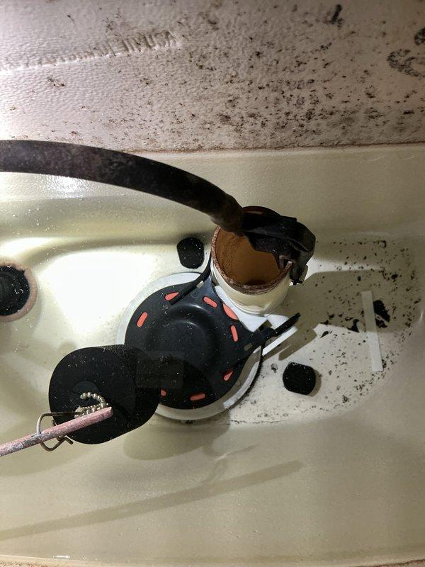 Responded to high water usage notification from water company. Upon inspection, investigated bathroom toilet as suspected source of leak. Examined toilet supply line connection, angle-stop valve, and floor-mounted plumbing assembly. Inspected braided stainless steel supply line, shut-off valve with escutcheon plate, and PVC riser pipe connection at tile floor interface. Documented visible water staining on grout lines and tile surfaces surrounding toilet base area. Photographed plumbing connections and mounting hardware to verify installation condition and identify potential leak points contributing to excessive water consumption.