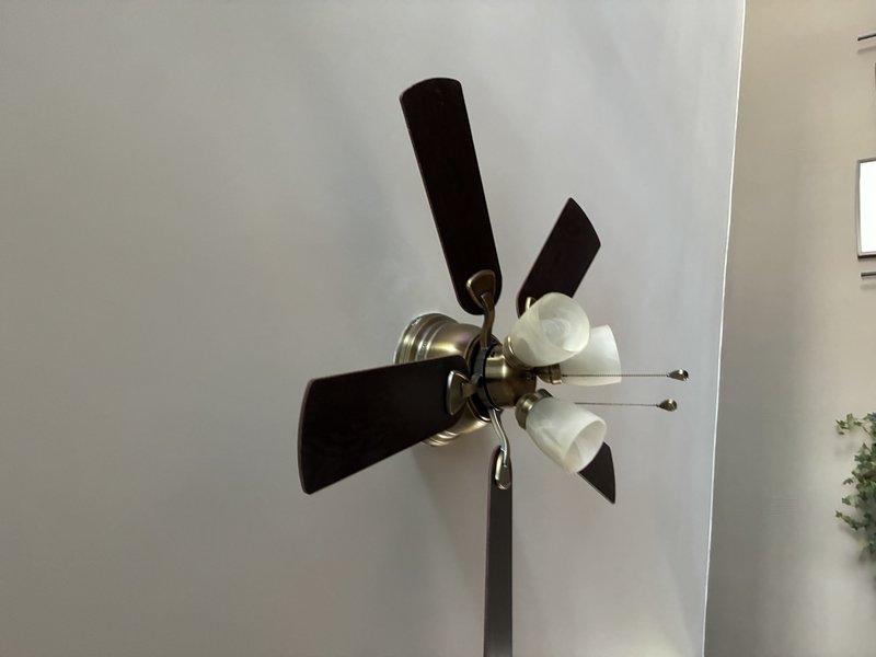 Removed existing pendant light fixture from ceiling and installed new ceiling fan with integrated light kit featuring three frosted glass shades. Completed all electrical connections, secured mounting bracket to ceiling junction box, and verified proper operation of fan and lighting functions.