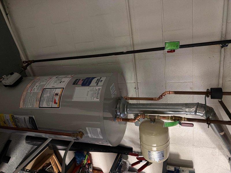 Installed a new 40-gallon short water heater in the utility room, including all necessary connections and fittings. Utilized a pre-staged water heater installation kit with required parts and components. Completed full installation with copper piping connections, expansion tank mounting, and proper venting, ensuring all safety standards and code requirements were met.