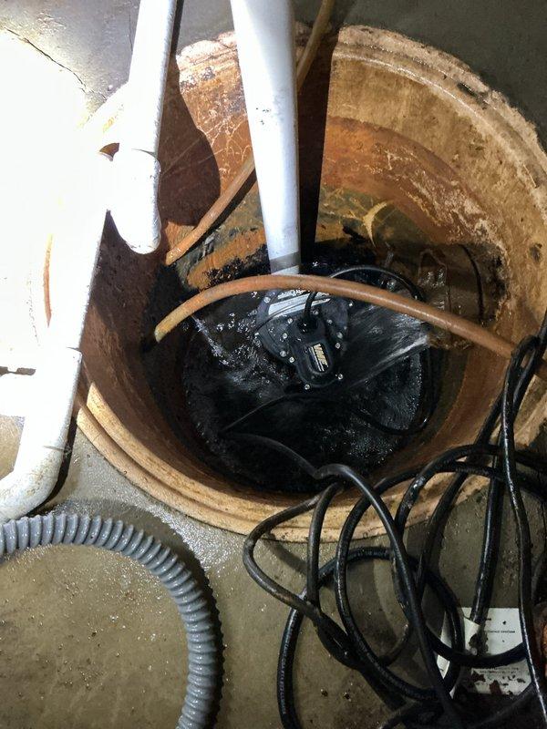 Responded to basement flooding emergency caused by failed primary sump pump and battery backup system. Removed existing dual-pump configuration including deteriorated primary pump, battery backup unit, and associated discharge piping. Installed new submersible sump pump with check valve assembly in existing concrete floor pit, secured vertical PVC discharge line with proper mounting hardware, and reconfigured plumbing to eliminate backup system per customer approval. Tested pump operation and float switch functionality to ensure proper activation and discharge flow.