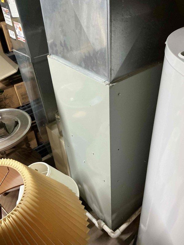 Conducted comprehensive on-site assessment for complete HVAC system replacement in residential utility area. Evaluated existing furnace and air conditioning equipment, including aged ductwork with visible weathering and discoloration. Documented current system configuration featuring green furnace unit with metal supply ductwork, air handler components, and associated condensate drain lines. Photographed all mechanical equipment, PVC piping, flexible ductwork connections, and clearance spacing for replacement planning. Prepared detailed replacement estimates for both furnace and air conditioning systems, accounting for existing infrastructure layout and accessibility requirements in basement mechanical room. Provided customer with multiple equipment options and scheduling information for proposed installation.