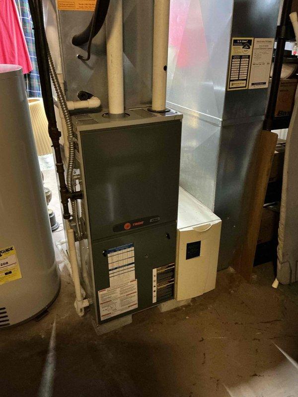 Conducted comprehensive on-site assessment for complete HVAC system replacement in residential utility area. Evaluated existing furnace and air conditioning equipment, including aged ductwork with visible weathering and discoloration. Documented current system configuration featuring green furnace unit with metal supply ductwork, air handler components, and associated condensate drain lines. Photographed all mechanical equipment, PVC piping, flexible ductwork connections, and clearance spacing for replacement planning. Prepared detailed replacement estimates for both furnace and air conditioning systems, accounting for existing infrastructure layout and accessibility requirements in basement mechanical room. Provided customer with multiple equipment options and scheduling information for proposed installation.