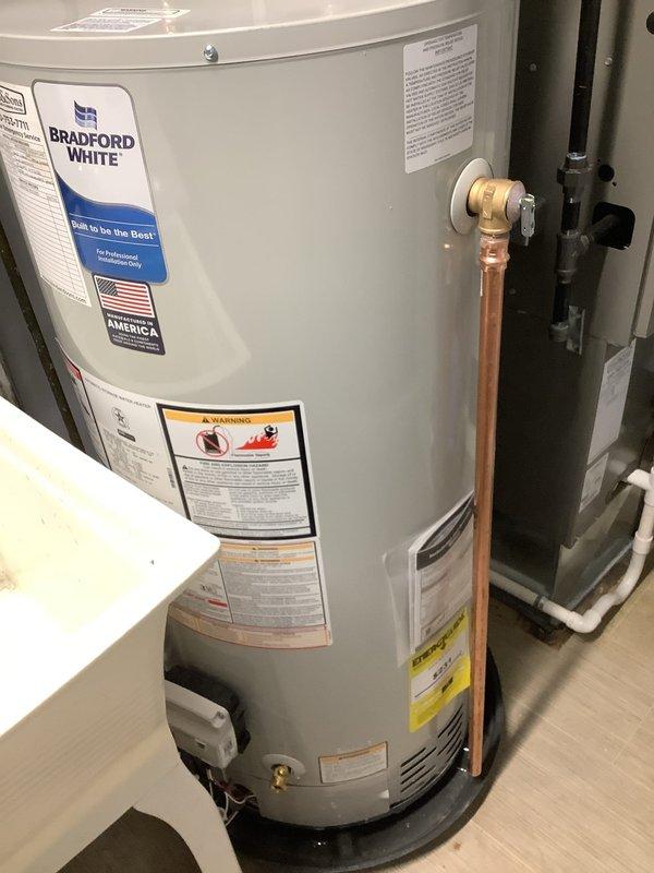 Installed a 40-gallon short Bradford White water heater with all required code upgrades, including proper expansion tank installation with copper piping, brass fittings, and pressure relief valve. The installation was completed in a residential utility space with proper connections to existing plumbing systems, ensuring compliance with current plumbing standards and manufacturer specifications for professional installation.