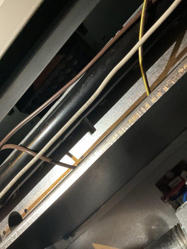 Completed routine MVP heating maintenance visit and system inspection. Examined mechanical infrastructure including refrigerant lines, condensate piping, and electrical conduit routing in ceiling space, verifying proper insulation and support. Performed diagnostic measurements using digital meter, recording supply air temperature of 66.42°F and verifying system operation within normal parameters. All components inspected and found operating satisfactorily with no immediate service needs identified.