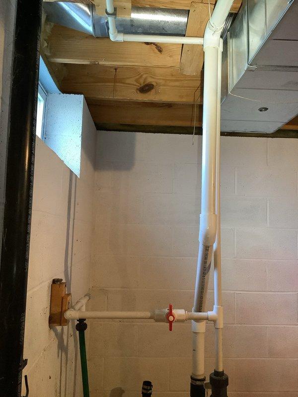 Conducted complimentary second opinion assessment of existing sump pump system in basement utility area. Performed thorough inspection of sump pump installation, including examination of discharge piping configuration with white PVC components, check valve assembly with red-handled shutoff valve, and drainage routing. Evaluated overall plumbing infrastructure in unfinished basement space, noting exposed floor joists, existing HVAC ductwork, and mechanical systems layout. Documented current system condition through photographic evidence showing pump location, piping arrangement, and surrounding utility connections. Provided professional assessment and recommendations regarding repair versus replacement options based on observed equipment condition and installation setup.