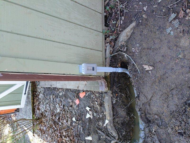 Installed underground electrical service to detached shed in rear yard by running 120-volt, 20-amp dedicated circuit through 1-1/4" conduit in homeowner-excavated trench. Connected new circuit to existing shed wiring and tied into main electrical system. Utilized oversized conduit to accommodate future upgrade potential to 60-amp subpanel if needed. Trench was dug 24 inches deep per code requirements for buried electrical conduit. Installed weatherproof junction box at building foundation and secured all conduit runs according to NEC standards.