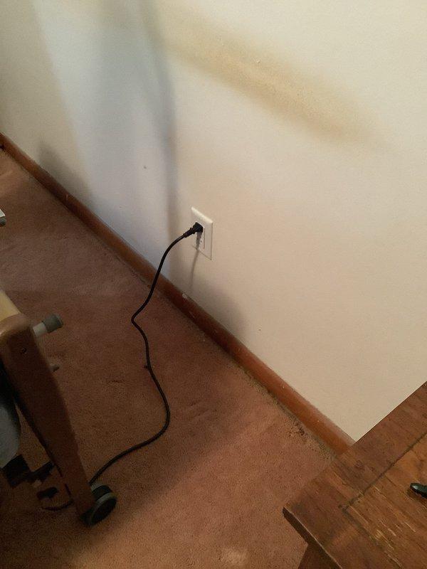 Conducted on-site evaluation for additional electrical outlet installation in residential interior space. Assessed existing electrical infrastructure, identified optimal locations for new receptacles based on room layout and current power distribution, and documented existing outlet placement near baseboards. Photographed areas requiring new outlet installation to support estimate preparation for expanding electrical service capacity in the space.