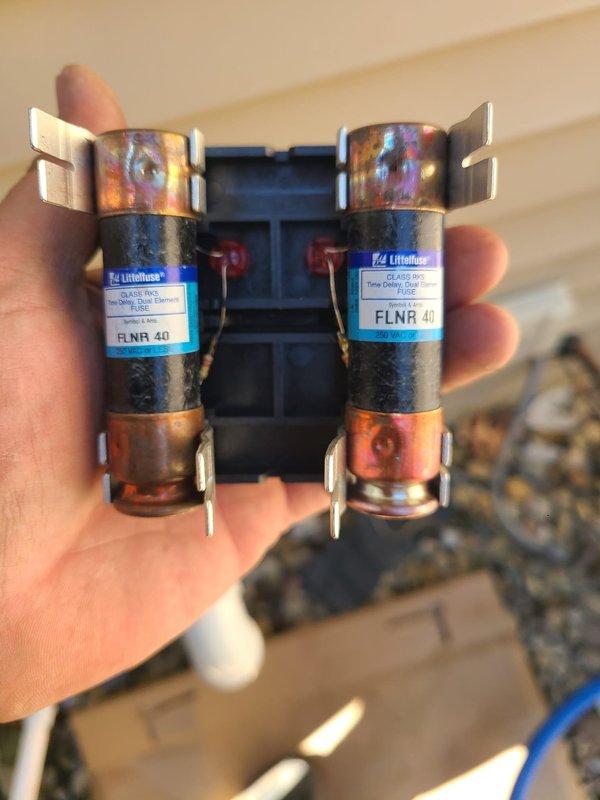 Removed existing zone control system from 80% AFUE air conditioning unit and reconfigured to single thermostat operation. Disconnected zone control panel, dampers, and associated wiring from the system. Installed new direct thermostat wiring to provide single-zone control of the complete HVAC system. Replaced dual-element time delay fuses at the disconnect to ensure proper electrical protection for the reconfigured system. Verified all refrigerant line connections at the outdoor condensing unit remain secure with proper insulation. Tested system operation under new single thermostat configuration and confirmed proper cooling cycle functionality.