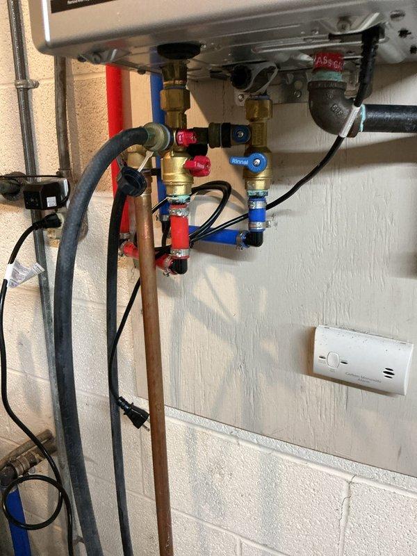 Performed annual maintenance flush on 1-year-old Navien tankless natural gas water heater. Isolated unit using service valves, connected flush cart with descaling solution, and circulated cleaning agent through heat exchanger to remove mineral deposits and sediment buildup. Flushed water contained visible sediment and discoloration, indicating successful removal of scale accumulation. Completed water quality test to assess incoming water hardness and mineral content for future maintenance recommendations.