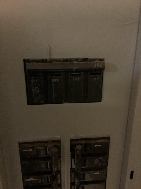 Responded to service call regarding separated conduit connection at primary electrical meter. Upon arrival, confirmed that utility company required licensed electrician to address the meter conduit separation before reconnecting service. Inspected dual electrical panel installation in recessed wall cavity and verified all circuit breaker connections and panel integrity. Documented existing conditions showing panels properly mounted with exposed insulation in surrounding wall opening, indicating active renovation work. All circuit breakers tested and confirmed operational in both panel boxes.