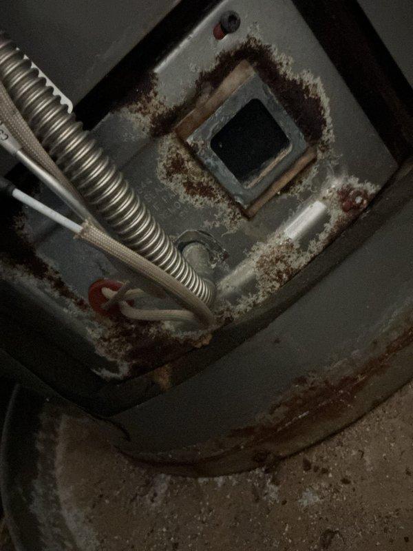 Responded to service call for non-functional tanked water heater at property. Upon inspection, found extensive rust, corrosion, and oxidation throughout the combustion chamber and heat exchanger components, indicating significant age-related deterioration and moisture exposure. Assessed overall condition of unit including plumbing connections, gas lines, and venting system. Documented equipment condition with photographs and provided professional assessment recommending full water heater replacement rather than repair due to advanced deterioration of critical components and safety concerns associated with compromised combustion chamber integrity.